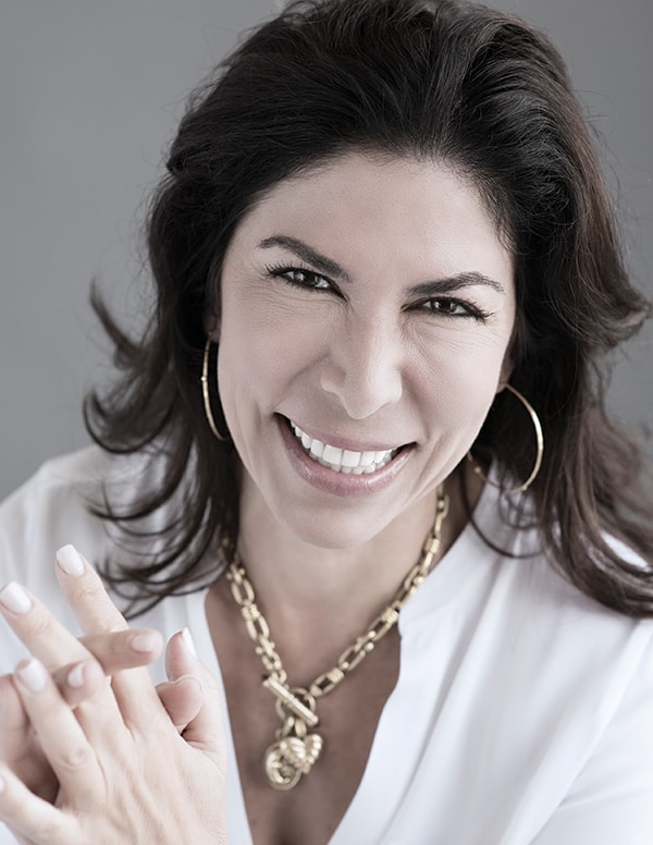 Headshot of Lisa Cypers Kamen, host of positive psychology podcast Harvesting Happiness and lifestyle consultant with a white shirt.