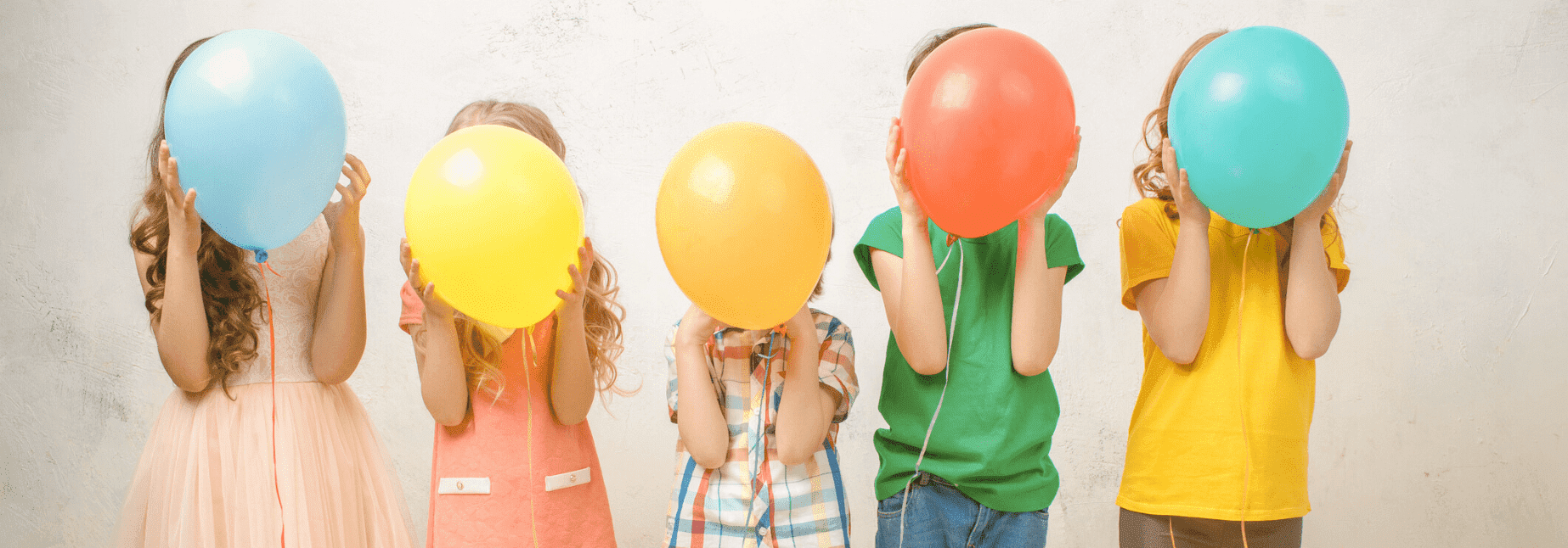 Children playing with colorful balloons and practicing mindfulness for a better pursuit of happiness