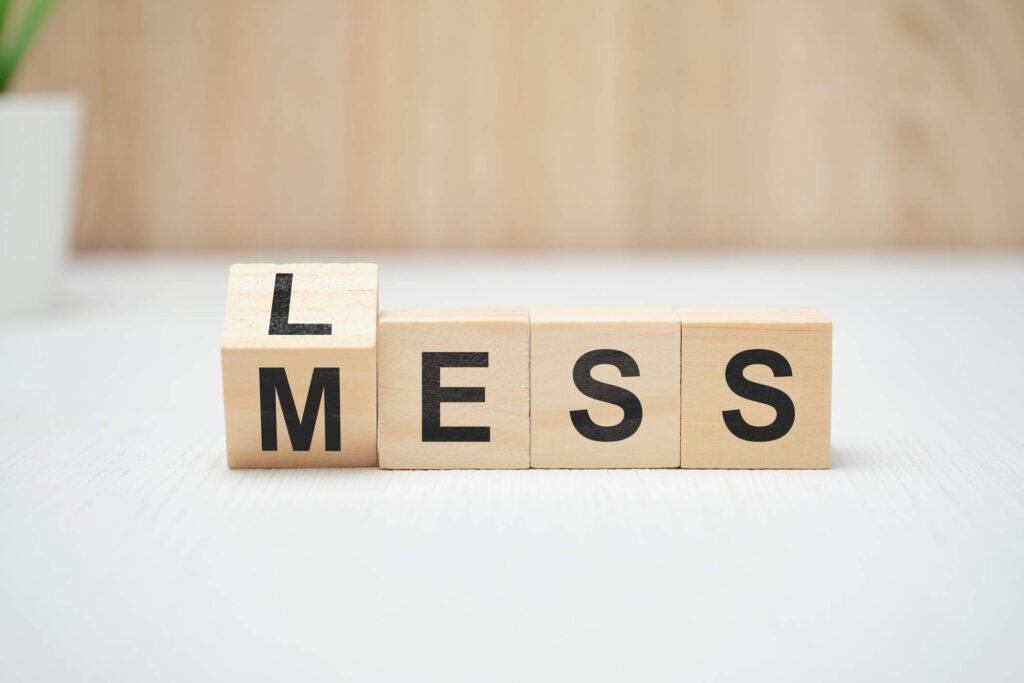 Less mess words on wooden blocks referring to less stress and decluttering for more happiness